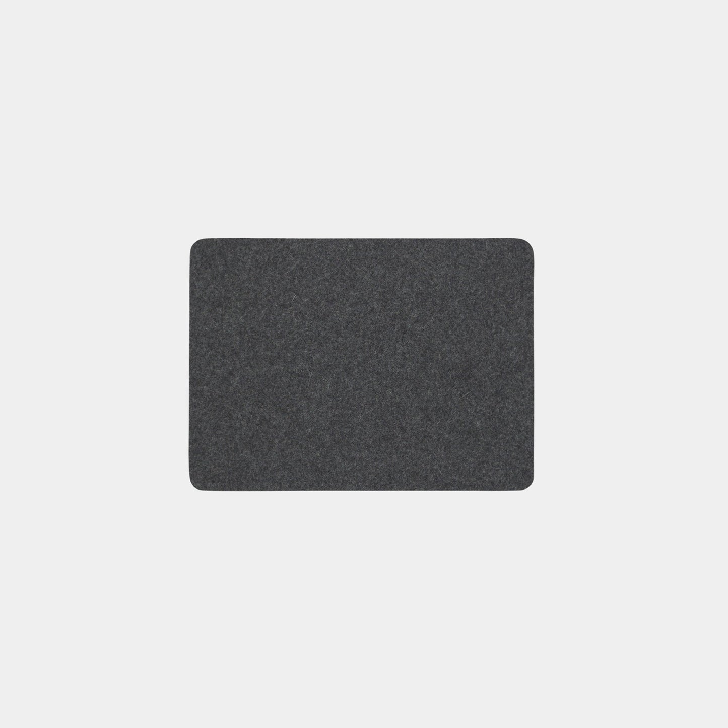 A rectangular, dark gray Felt Tops mat with rounded corners is centered on a plain, light gray background.