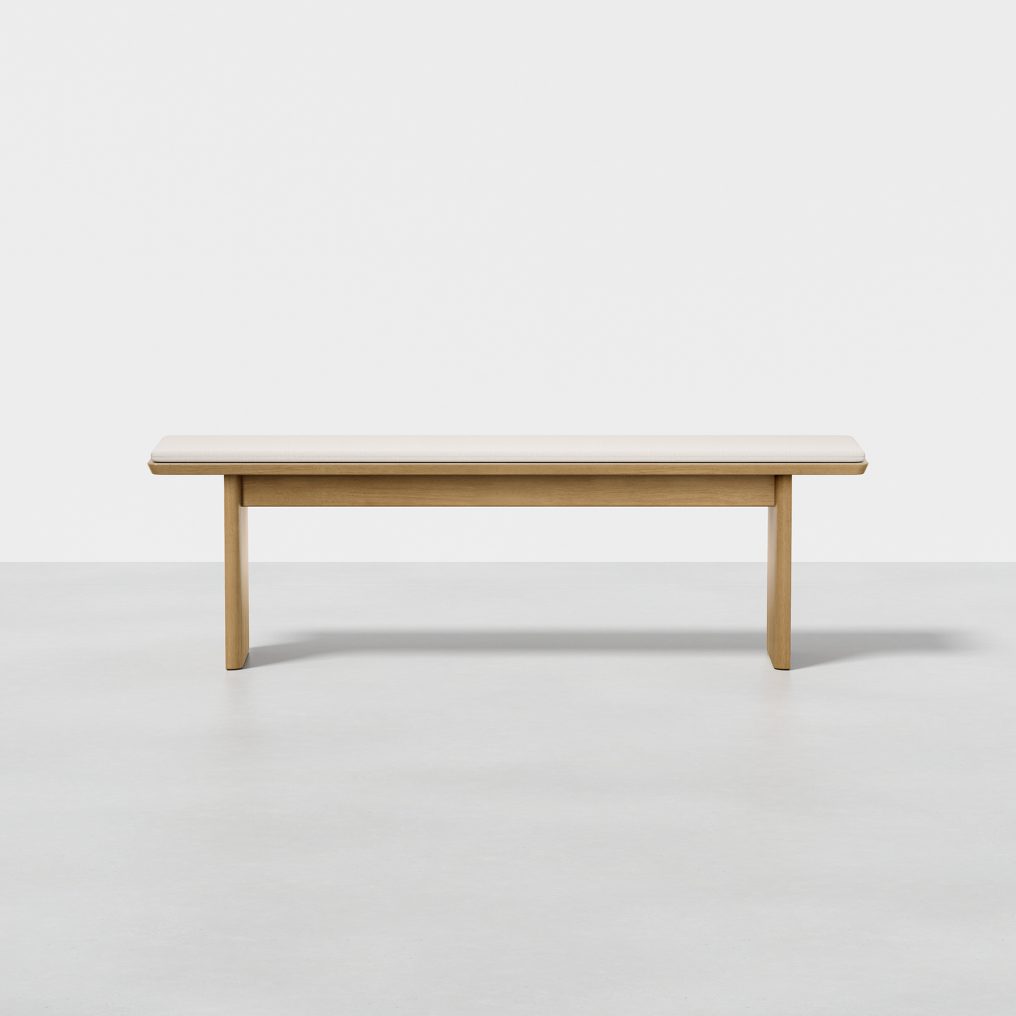 The Pillar Bench features a simple rectangular design, clean lines, and a light wood finish, showcased against a plain white background.