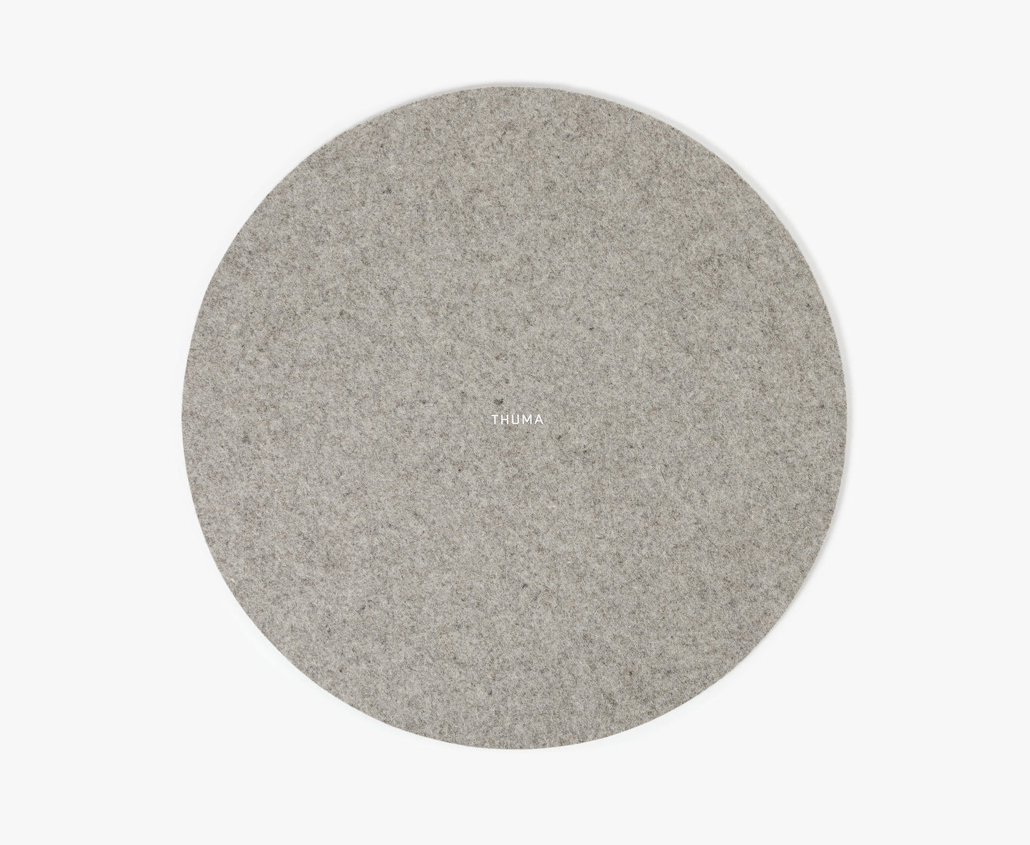 A round, light gray Felt Tops pad with THUMA in small white letters at the center, displayed on a plain white background.