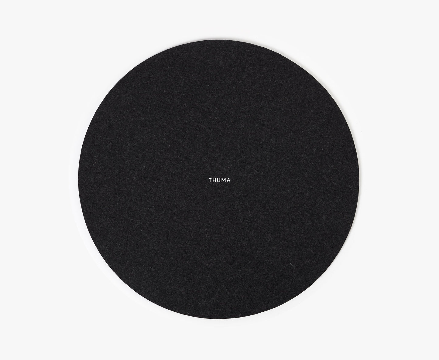 A round black Felt Tops pad with THUMA printed in white at the center, displayed on a plain white background.