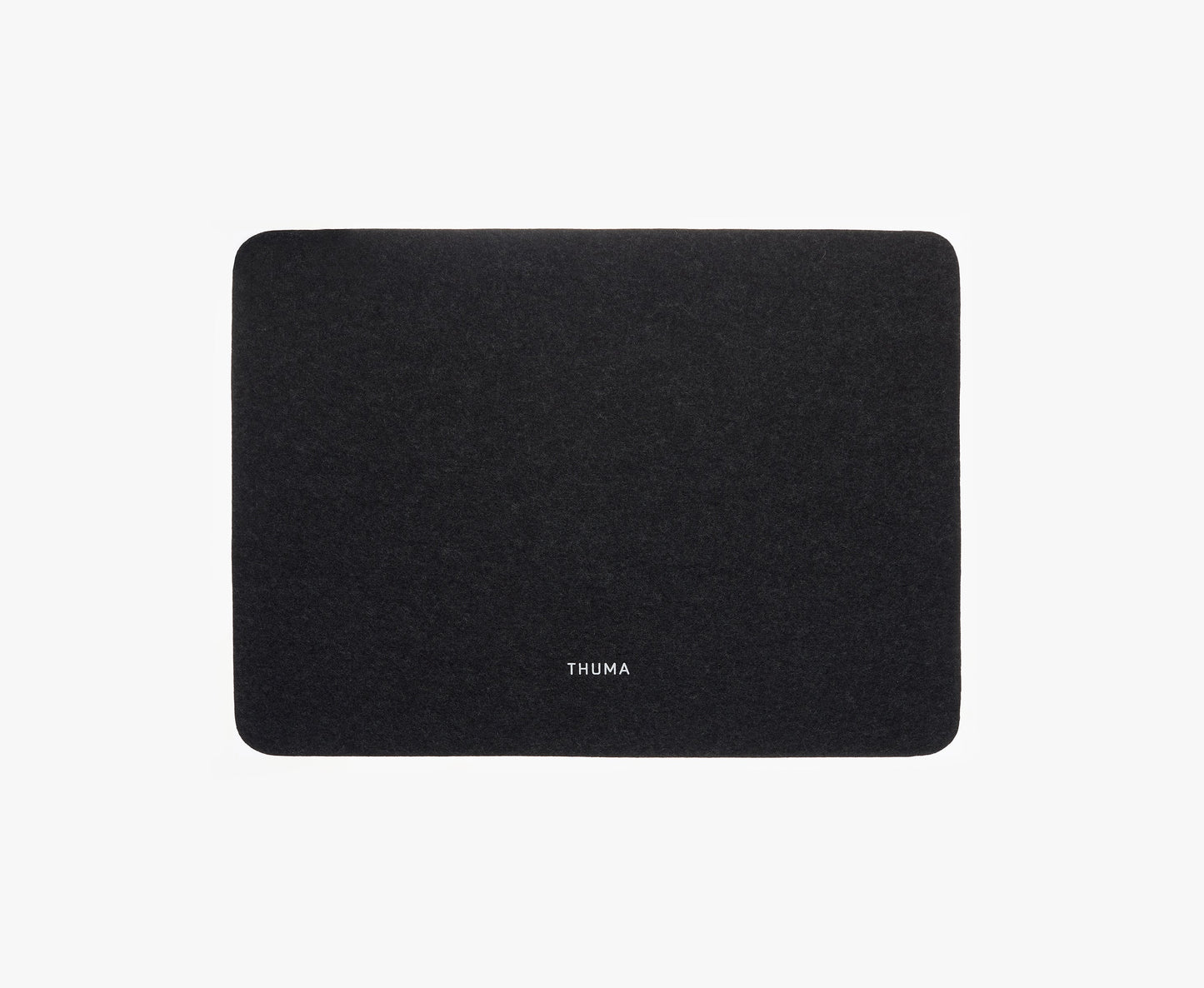 A rectangular, dark gray Felt Tops mat with rounded corners and THUMA in white text centered near the bottom is shown on a plain white background.
