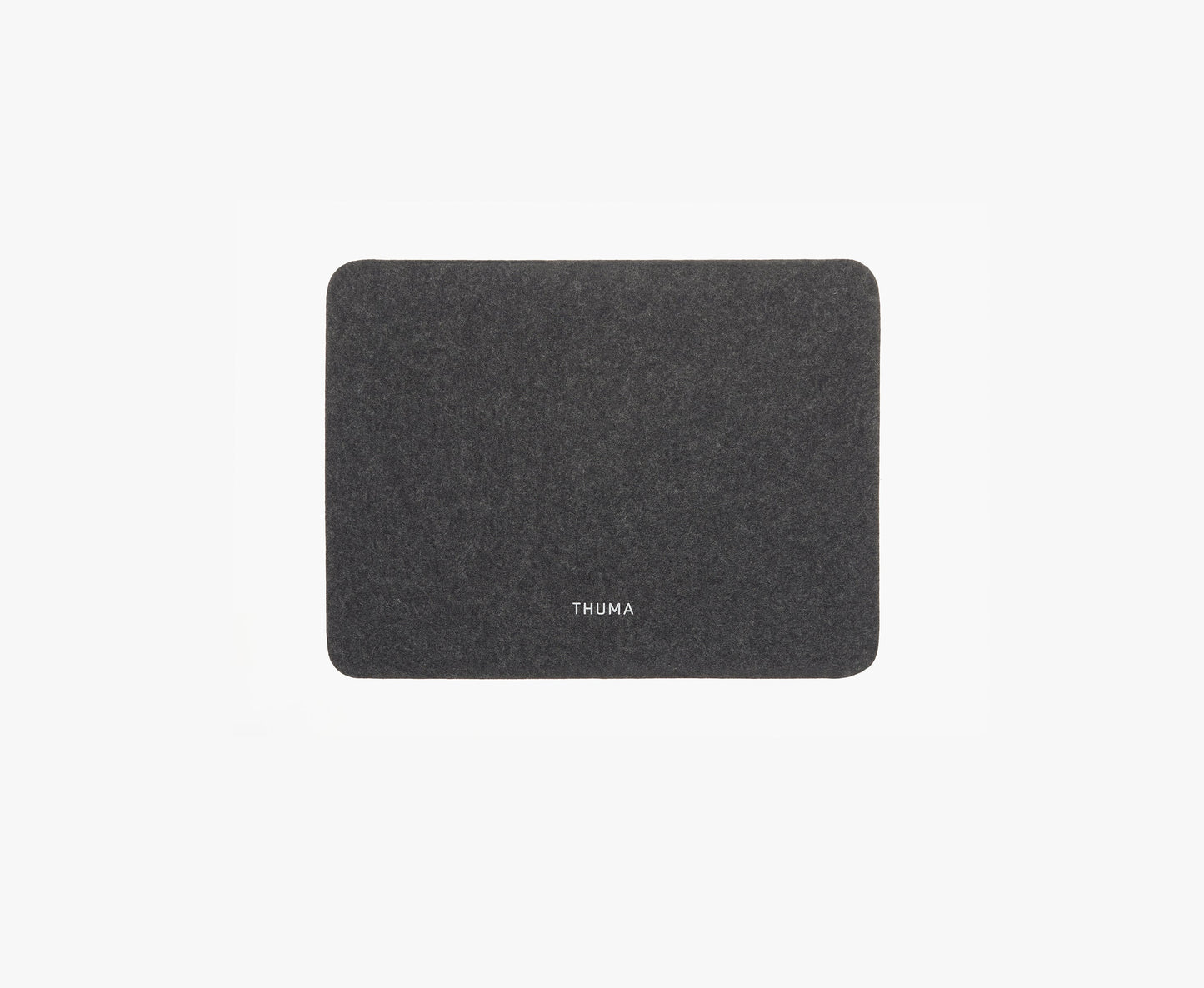 The Felt Tops is a rectangular dark gray felt mat with rounded corners and THUMA in white at the center, shown on a plain white background.