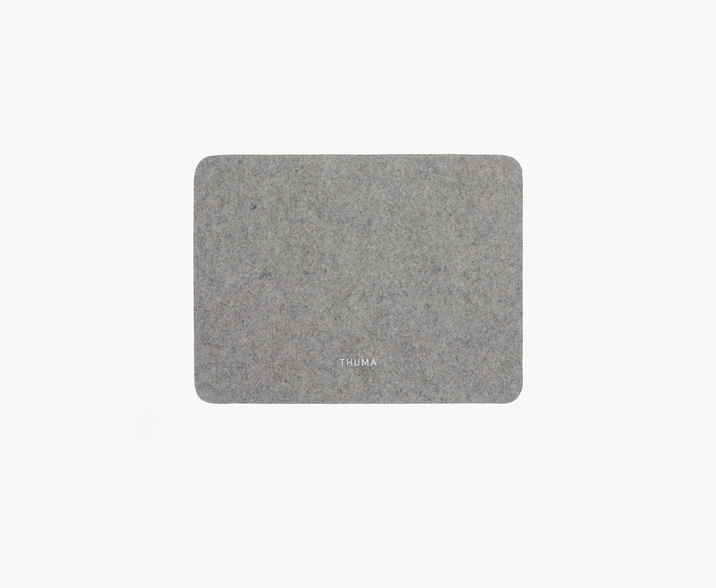 A rectangular, gray Felt Tops mat with rounded corners and THUMA in small white letters near the bottom center, shown against a plain white background.
