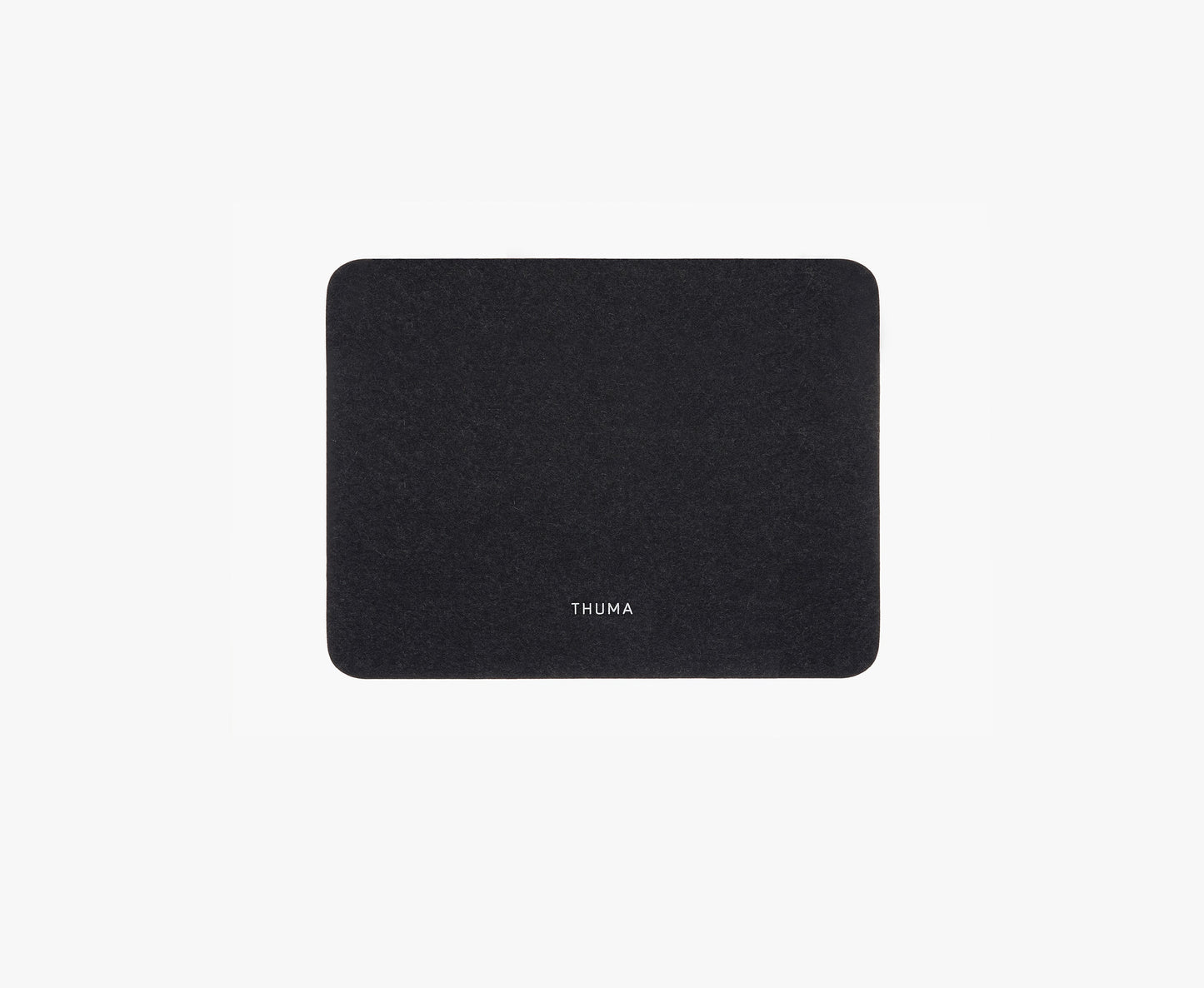 The Felt Tops is a rectangular, dark gray felt mat with rounded corners and THUMA printed in white at the center, displayed against a plain white background.