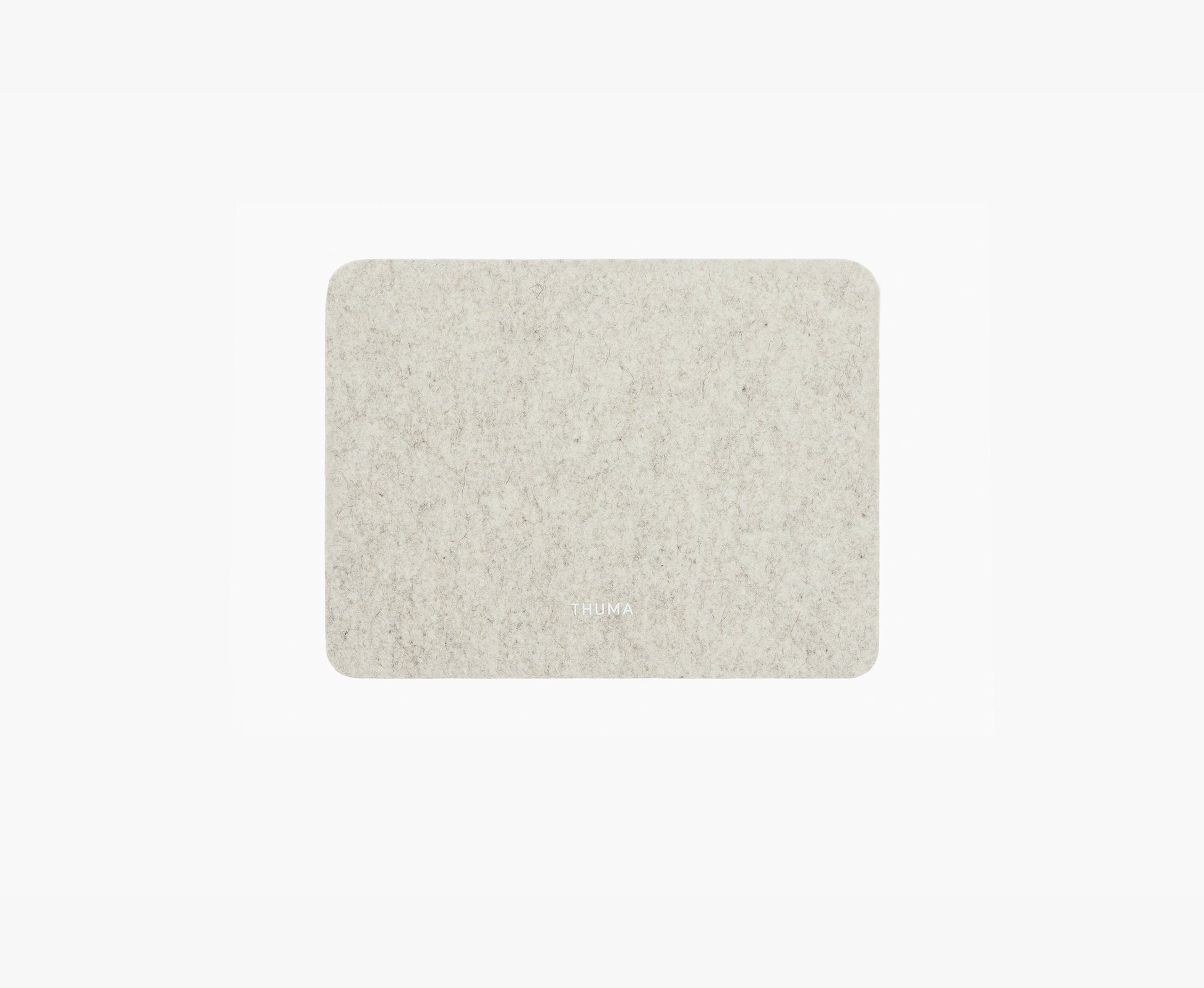 The Felt Tops is a rectangular, light grey felt mat with rounded corners and a subtle TRUMA logo at the bottom center, shown on a plain white background.
