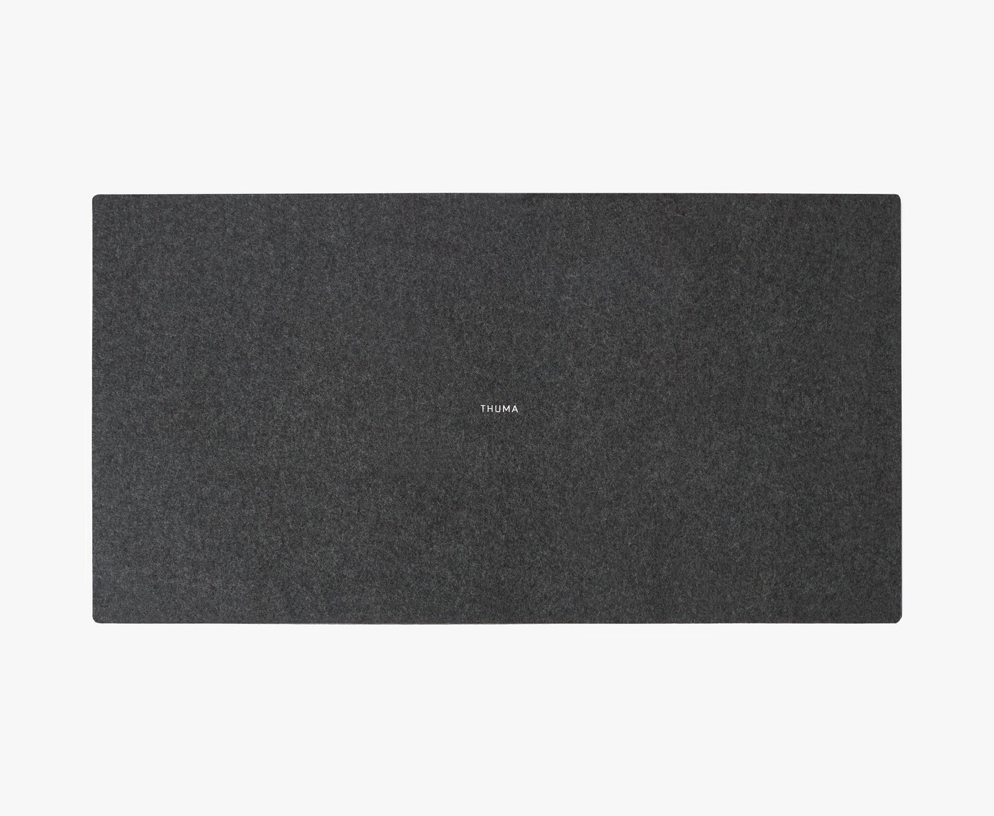 A dark gray rectangular Felt Tops desk pad with rounded corners and THUMA printed in small white letters at the center, displayed on a plain white background.