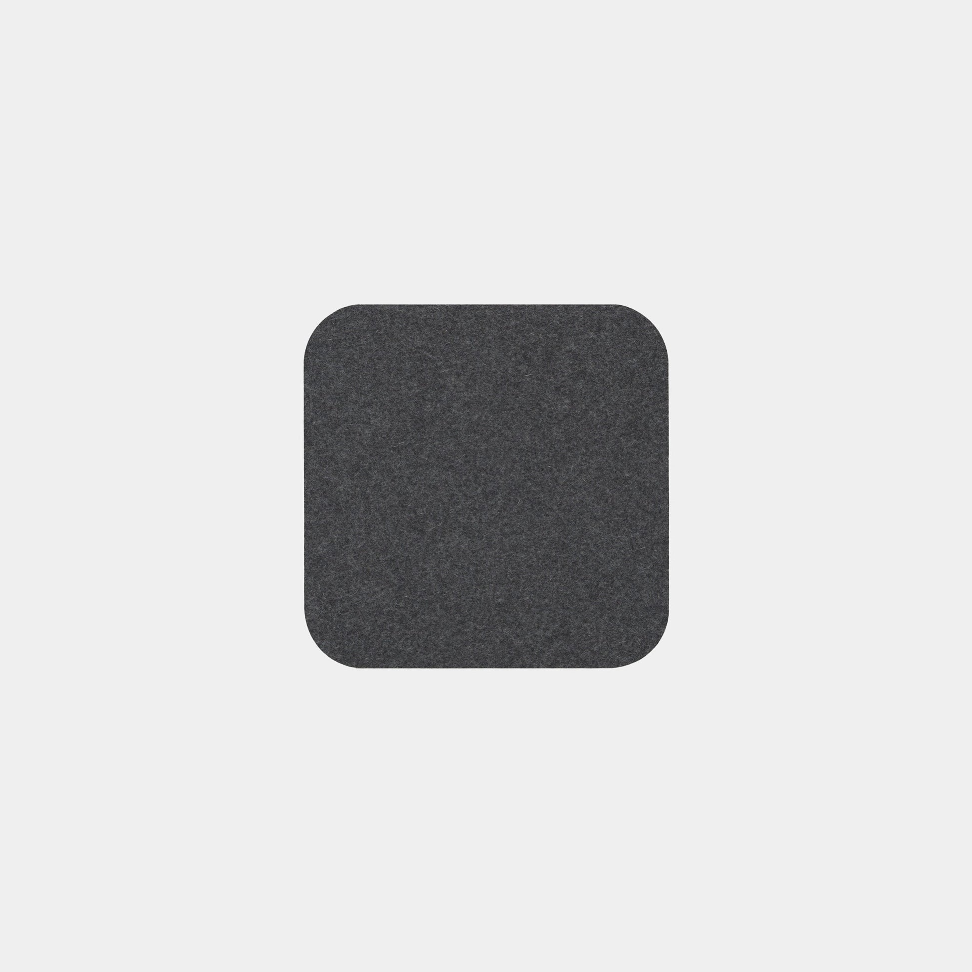 A single Felt Tops dark gray, square felt pad with rounded corners is centered on a plain light gray background.