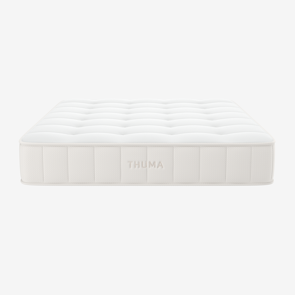 The Hybrid Mattress features a white, tufted design with subtle stitching and THUMA embroidered on the side, displayed against a plain white background.