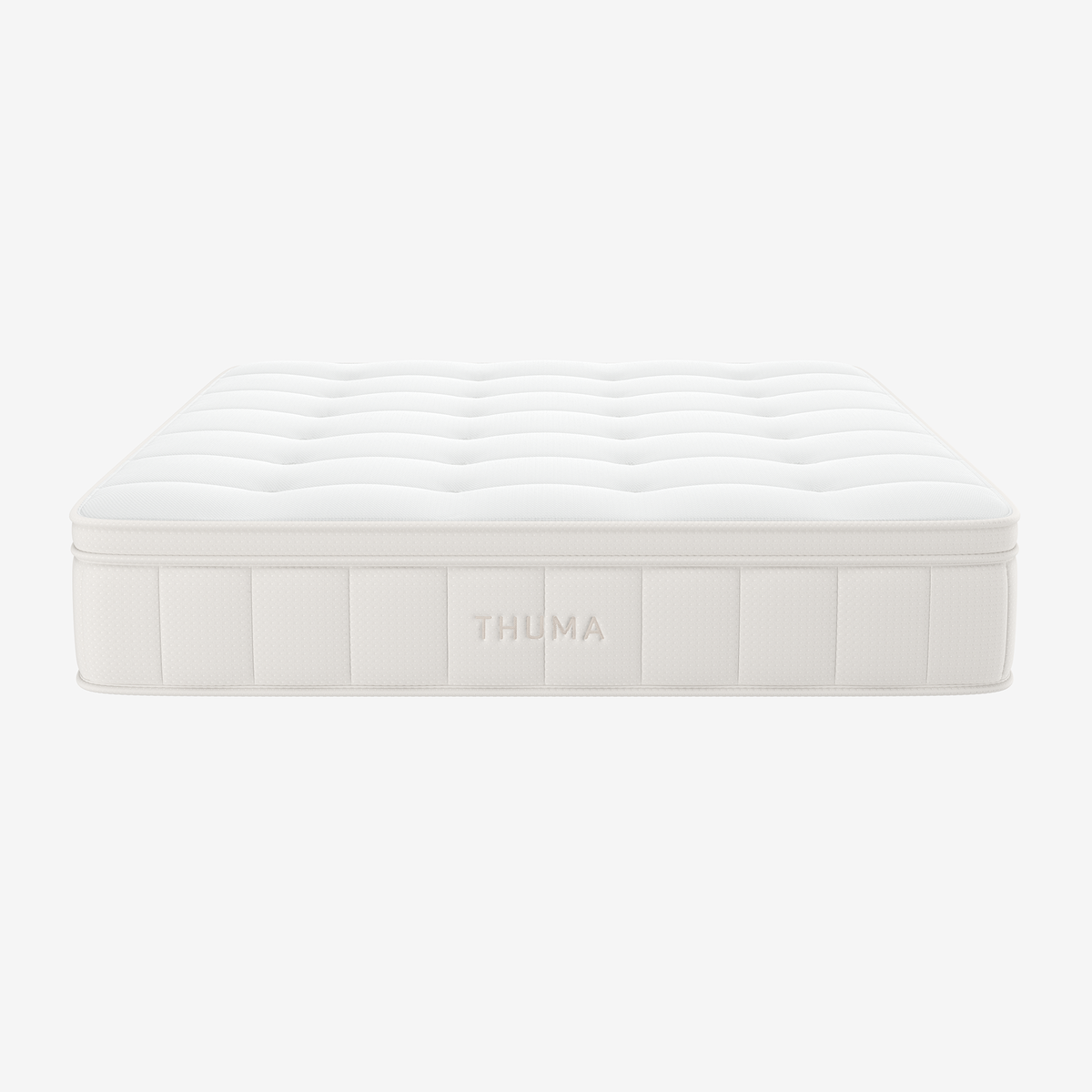 The Hybrid Mattress is a white, rectangular mattress featuring a quilted top and THUMA embroidery on the side, displayed against a plain white background.