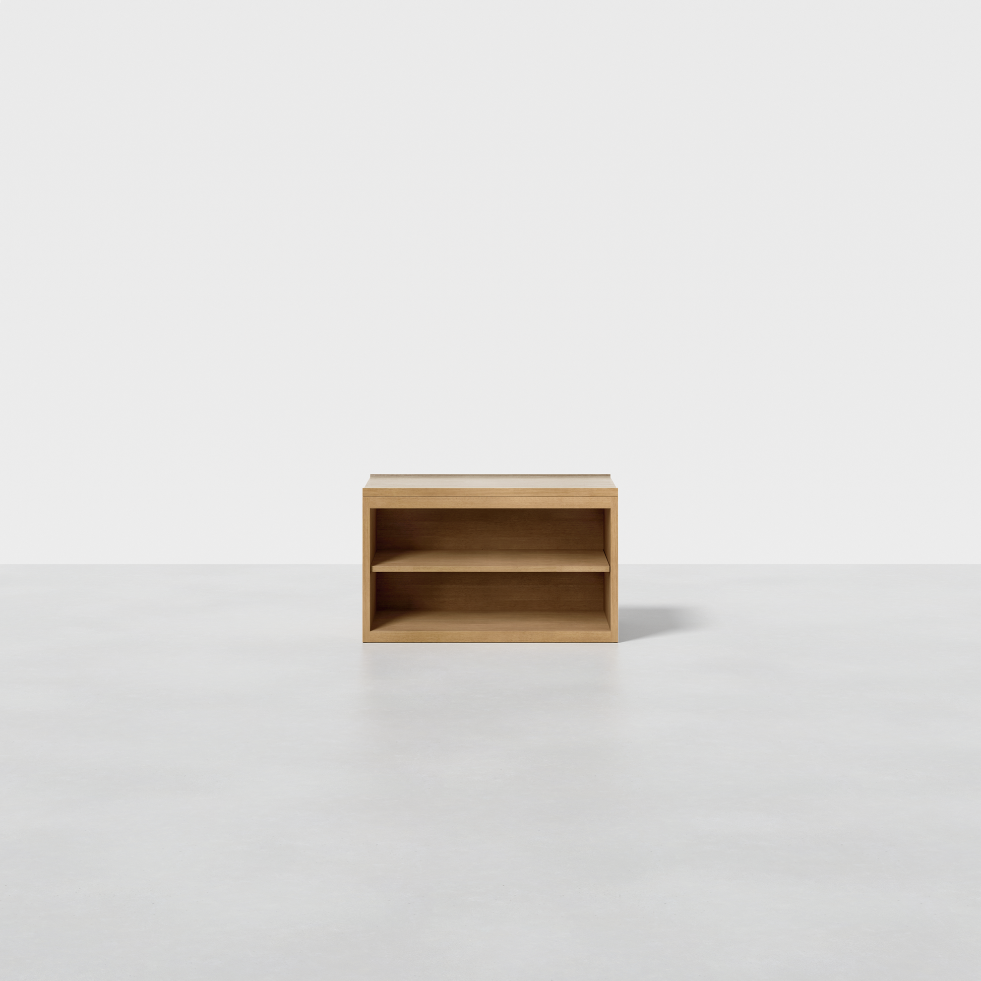 The Nest Nightstand Open is a small, rectangular wooden shelf with an open front and one interior shelf, shown on a light gray floor against a plain white background.