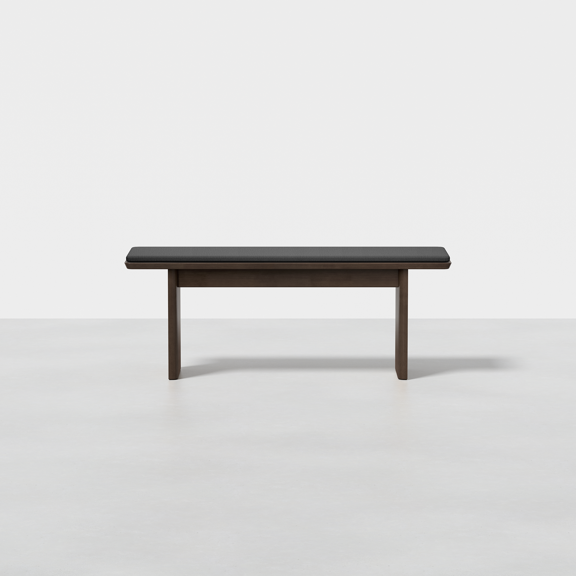 The Pillar Bench features a modern design with clean lines and a dark wooden rectangular seat, shown against a plain white background.