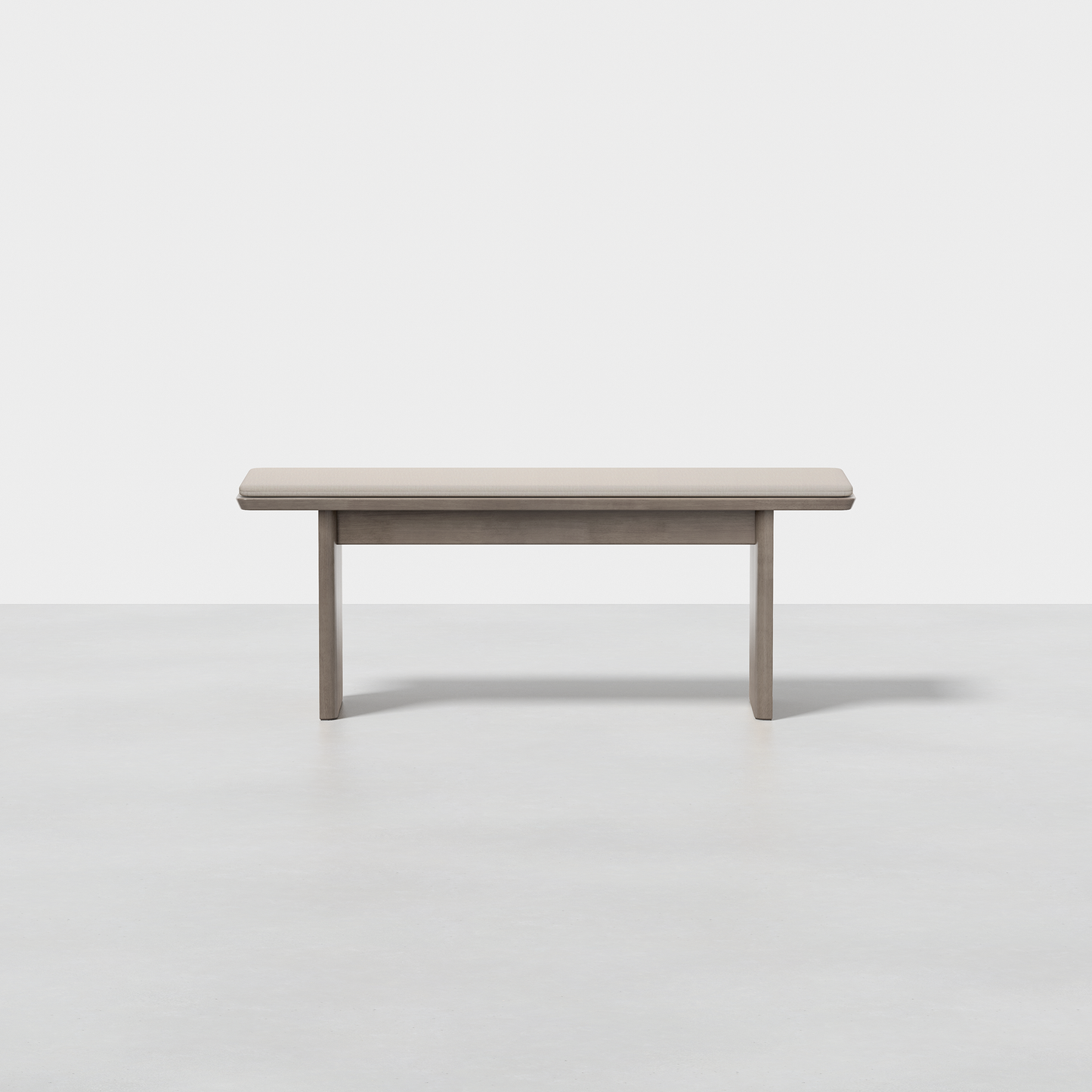 The Pillar Bench features a simple, rectangular wooden design with clean lines and a light gray finish, shown against a plain white background.