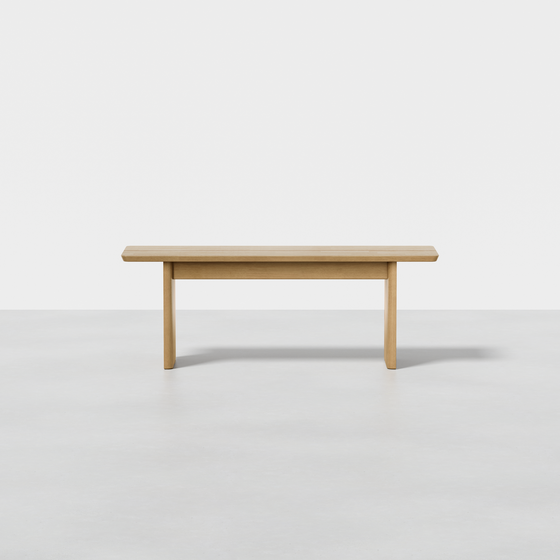 The Pillar Bench features a rectangular wooden seat and three straight legs, displayed against a plain white background and a light-colored floor.