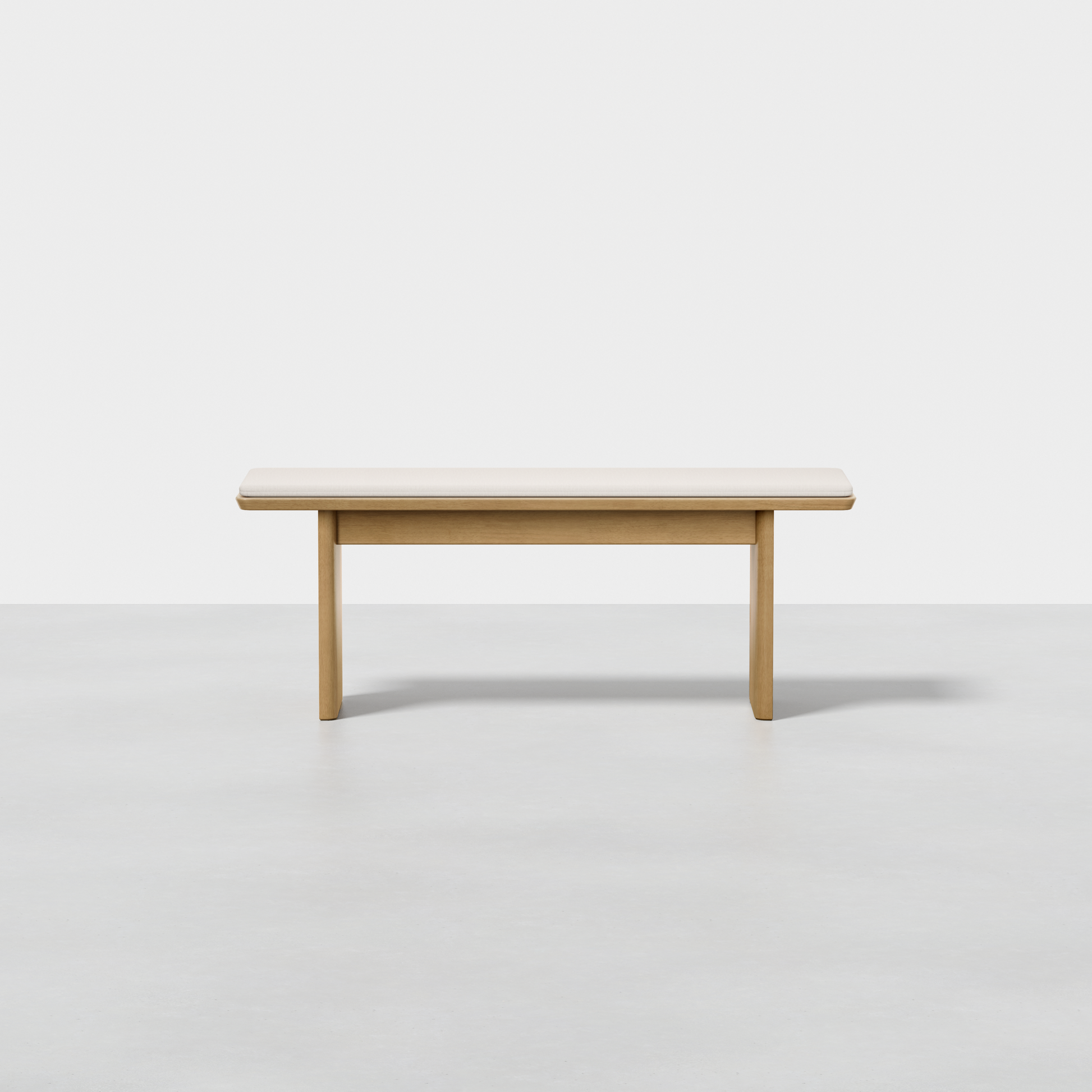 The Pillar Bench features a simple, modern design with clean lines and a light wood finish, shown against a plain white background on a light gray floor.