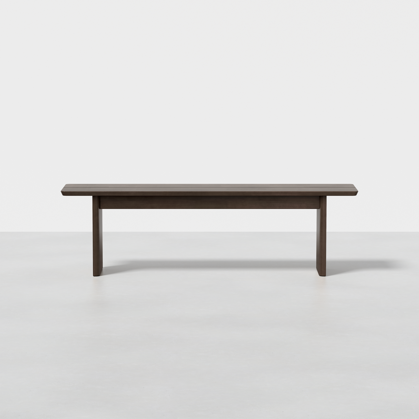 The Pillar Bench is a simple, modern wooden bench with a dark finish, flat top, and four straight legs, shown against a plain white background.