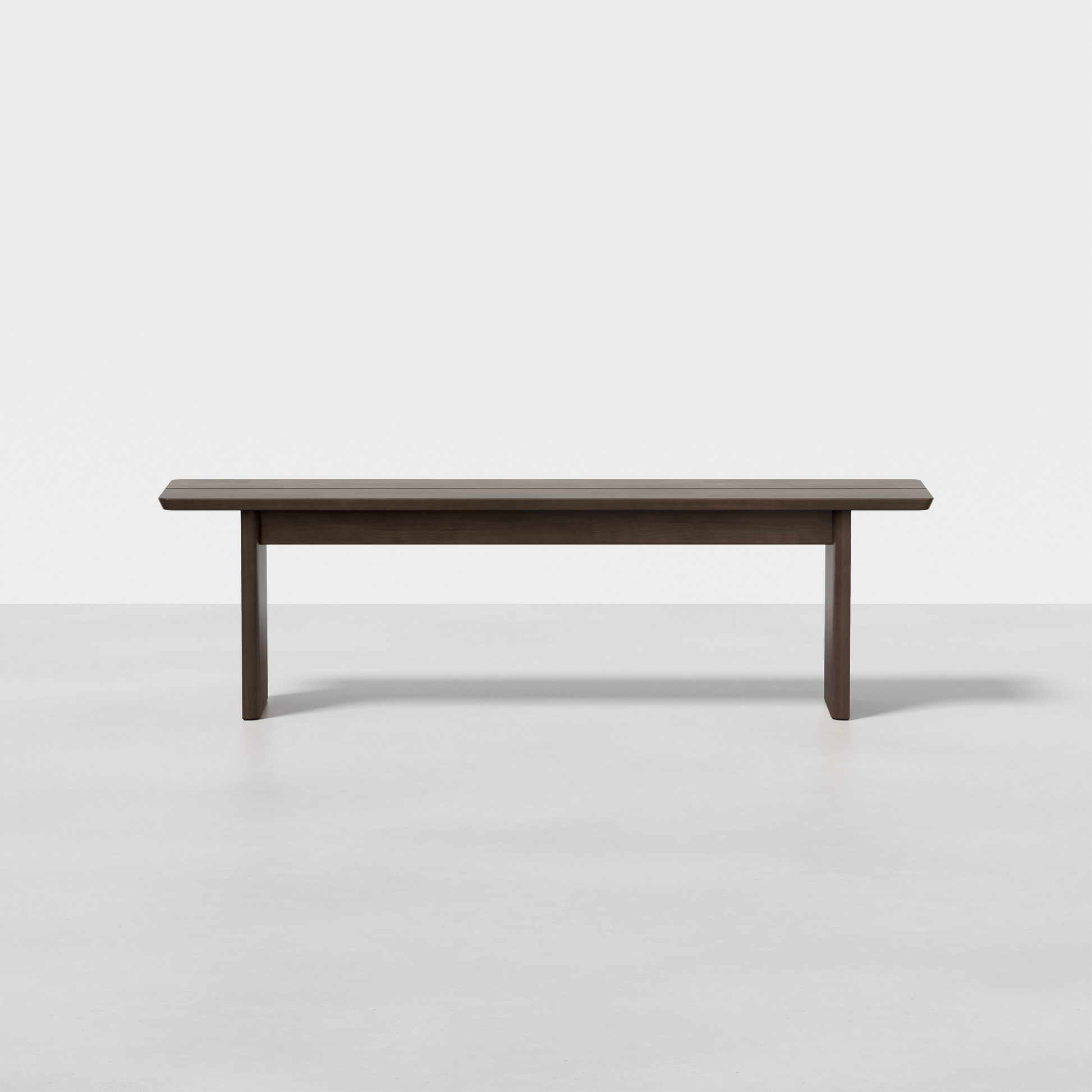 The Pillar Bench is a simple, modern wooden bench with a dark finish, flat top, and four straight legs, shown against a plain white background.