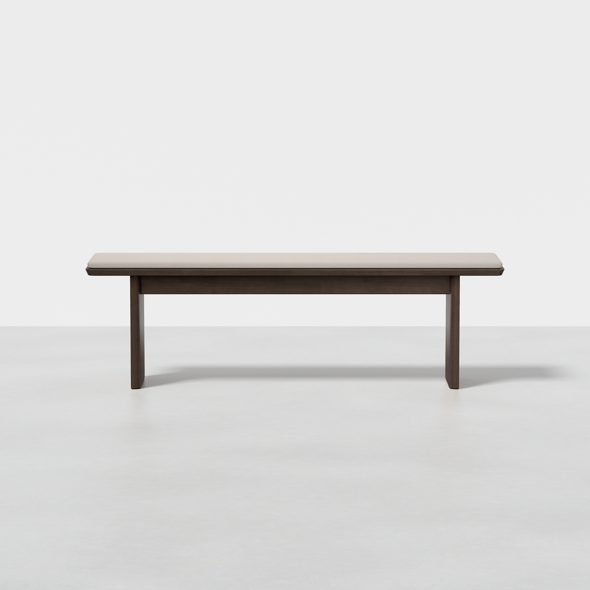 The Pillar Bench is a minimalist, rectangular wooden bench featuring clean lines and a dark finish, shown on a smooth light-colored floor against a plain white background.