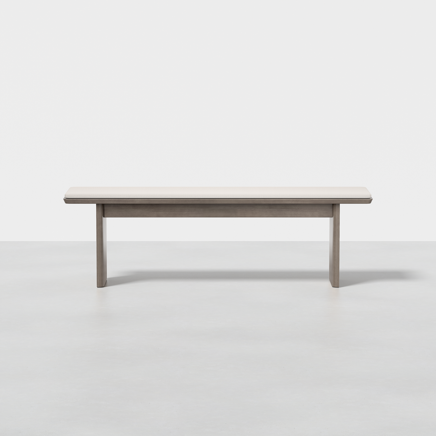 The Pillar Bench is a simple, modern wooden bench with a light finish, shown from the front against a plain white background and set on a smooth, light floor.
