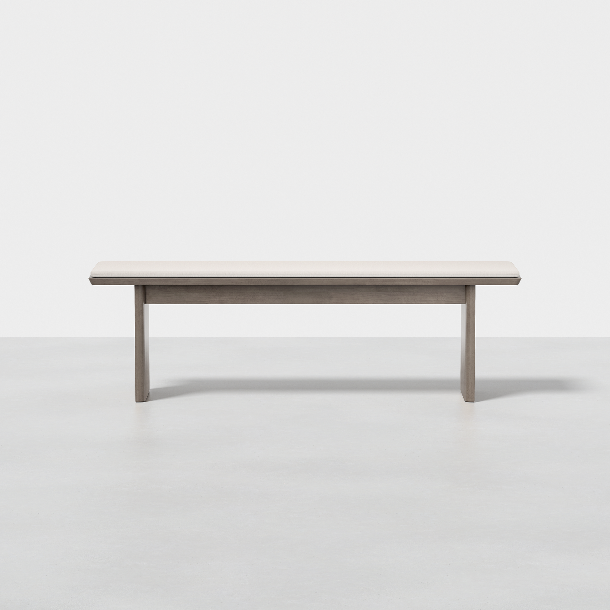 The Pillar Bench is a simple, modern wooden bench with a light finish, shown from the front against a plain white background and set on a smooth, light floor.