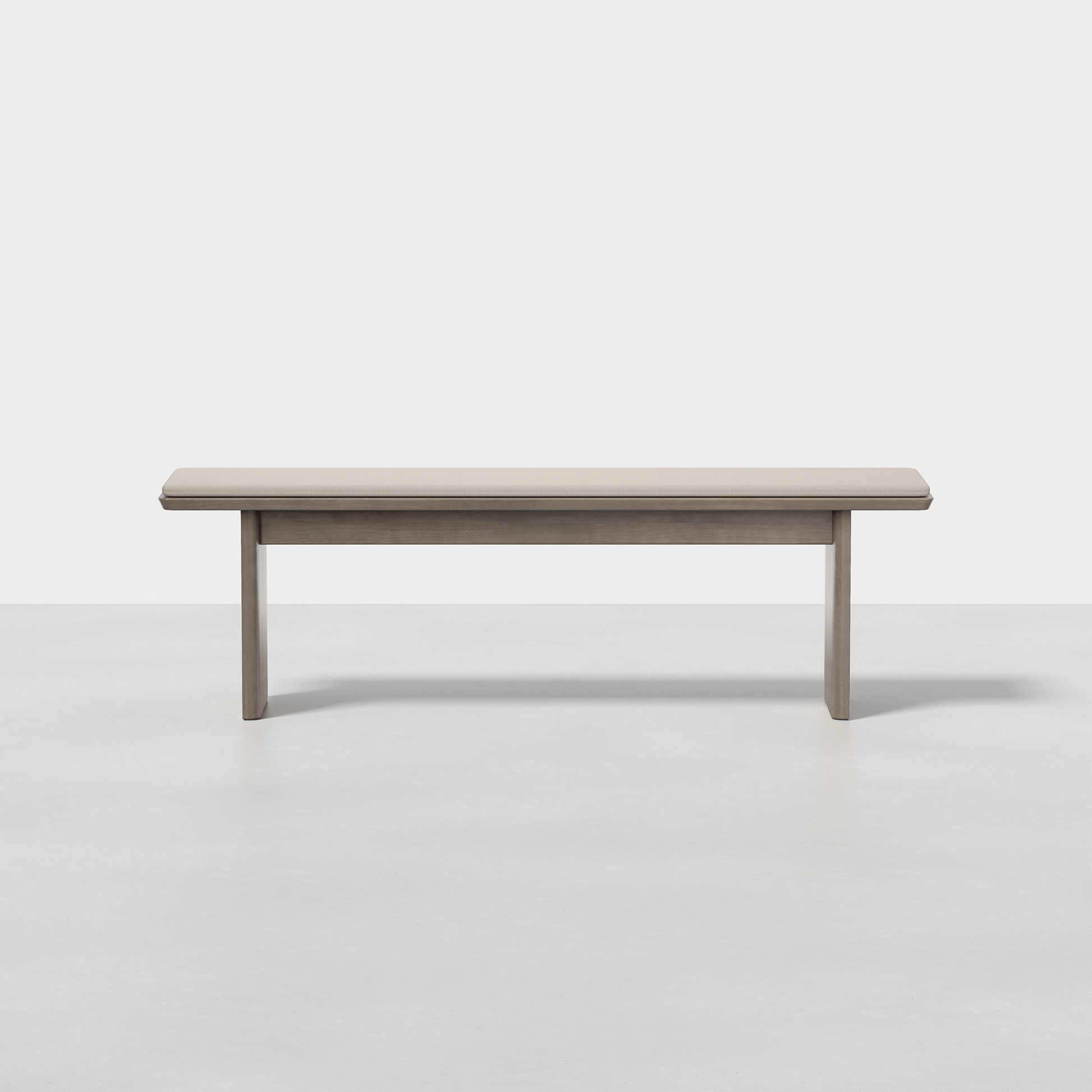 The Pillar Bench features a rectangular seat and four straight legs, finished in light gray, and is shown on a smooth, light floor against a white background.