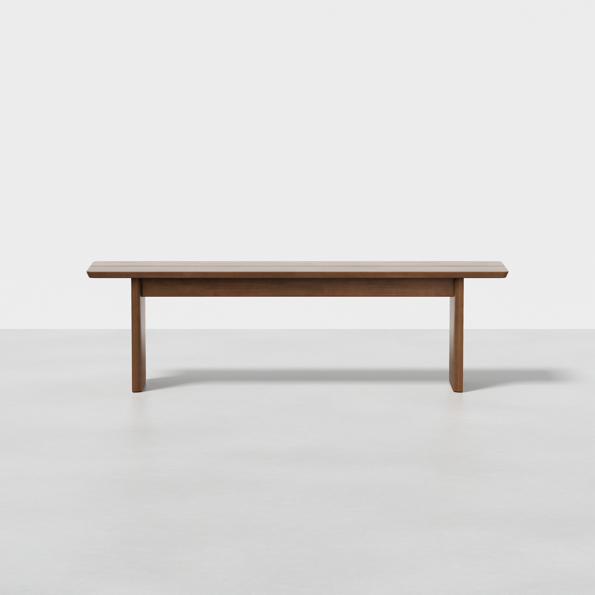 The Pillar Bench is a simple, rectangular wooden bench with clean lines and tapered legs, shown on a plain white floor against a white background.