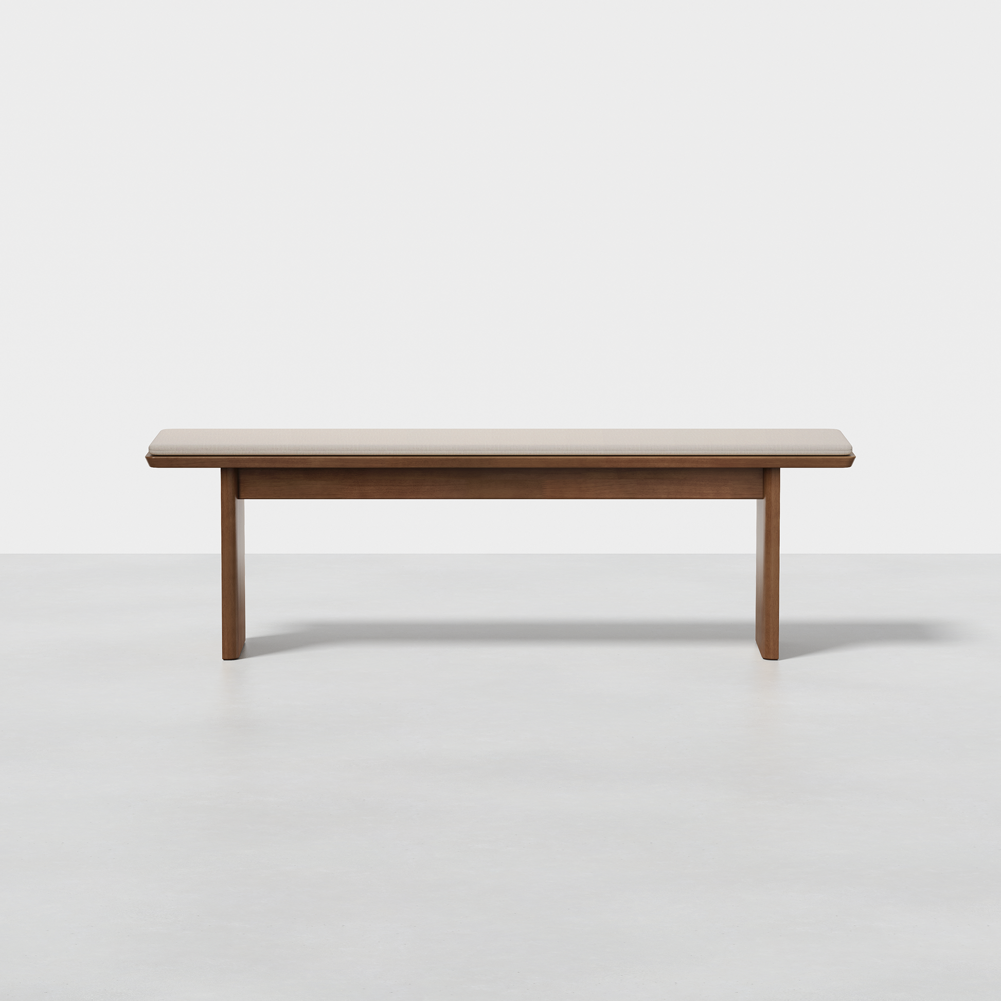 The Pillar Bench features a simple rectangular wooden seat with straight legs, shown on a light gray floor against a plain white background.
