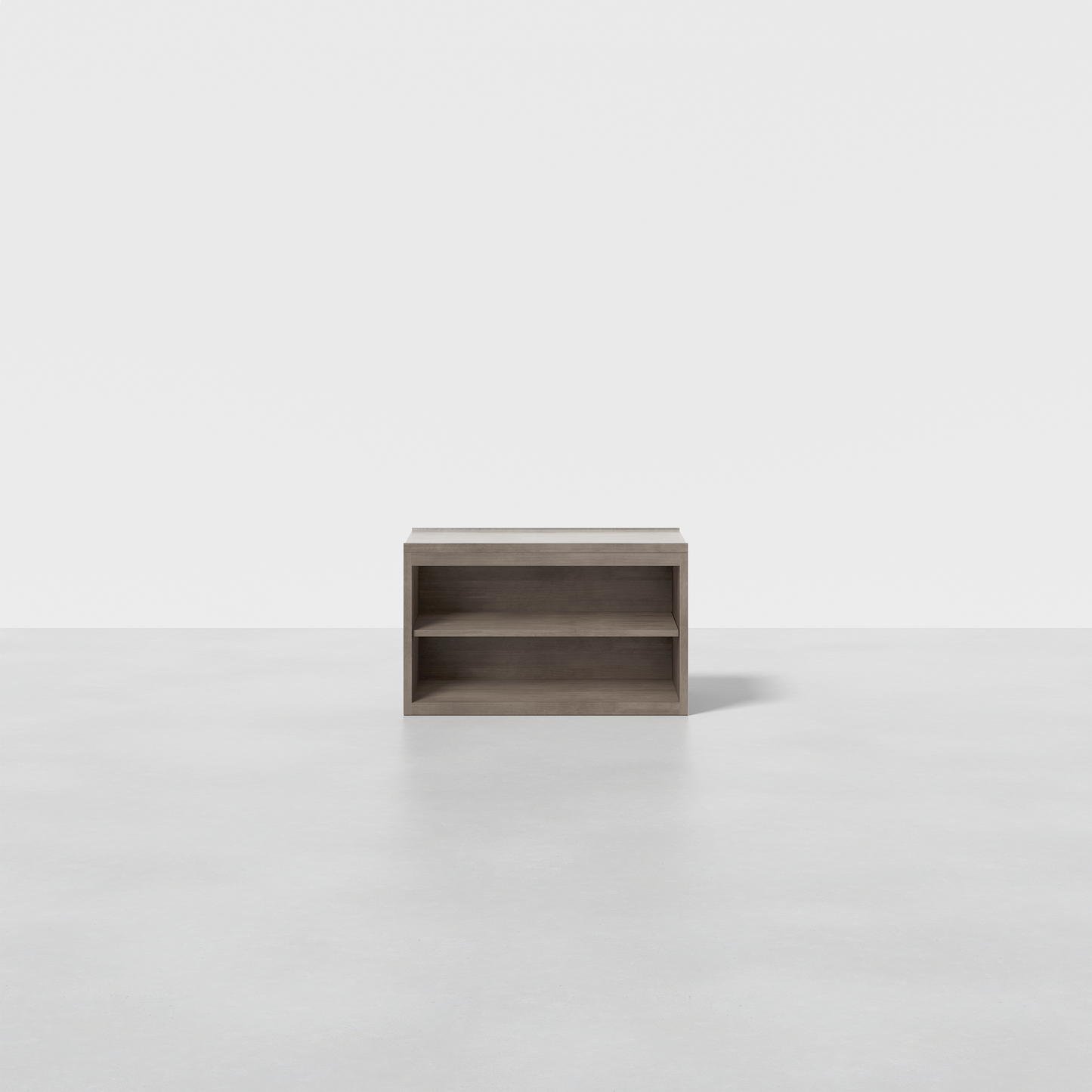 The Nest Nightstand Open, a minimalist wooden shelf with two open compartments, is showcased on a smooth light gray floor against a plain white background.